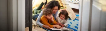 Mom and kids reading on the floor - Inspect-All Services Pest Control in Atlanta, GA
