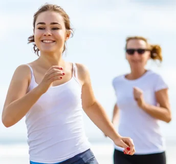 Women smiling and running on the beach - Inspect-All Services Pest Control in Atlanta, GA