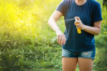 Woman spraying bug repellant on her arm - stop getting mosquito bits in your yard with Inspect-All Services Pest Control in Atlanta, GA