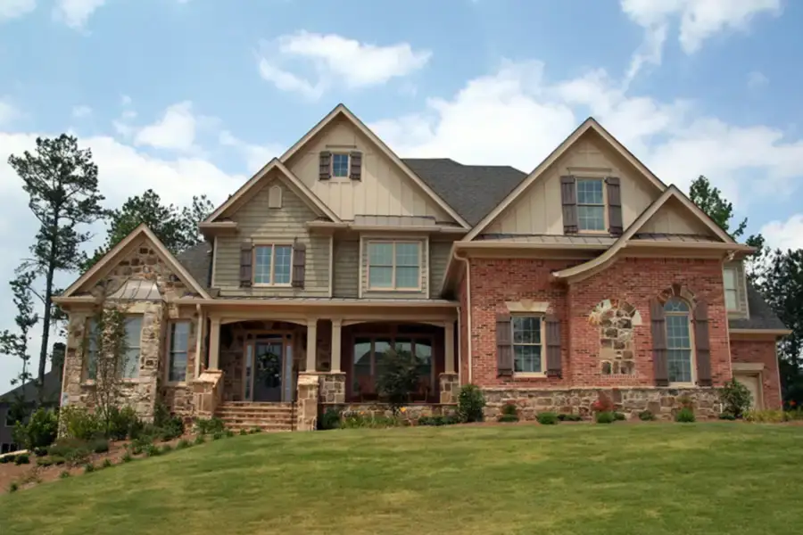 Brick modern luxury home with freshly manicured grass